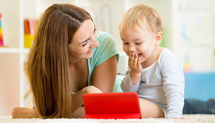 mother and kid play on tablet computer