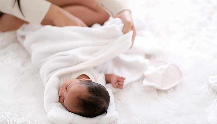 Newborn baby in a white cloth